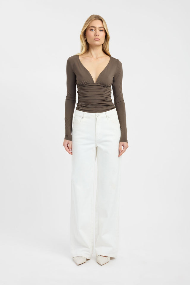 Showcasing the Solis Core Long Sleeve Top in olive with fitted silhouette and plunge neckline on-body